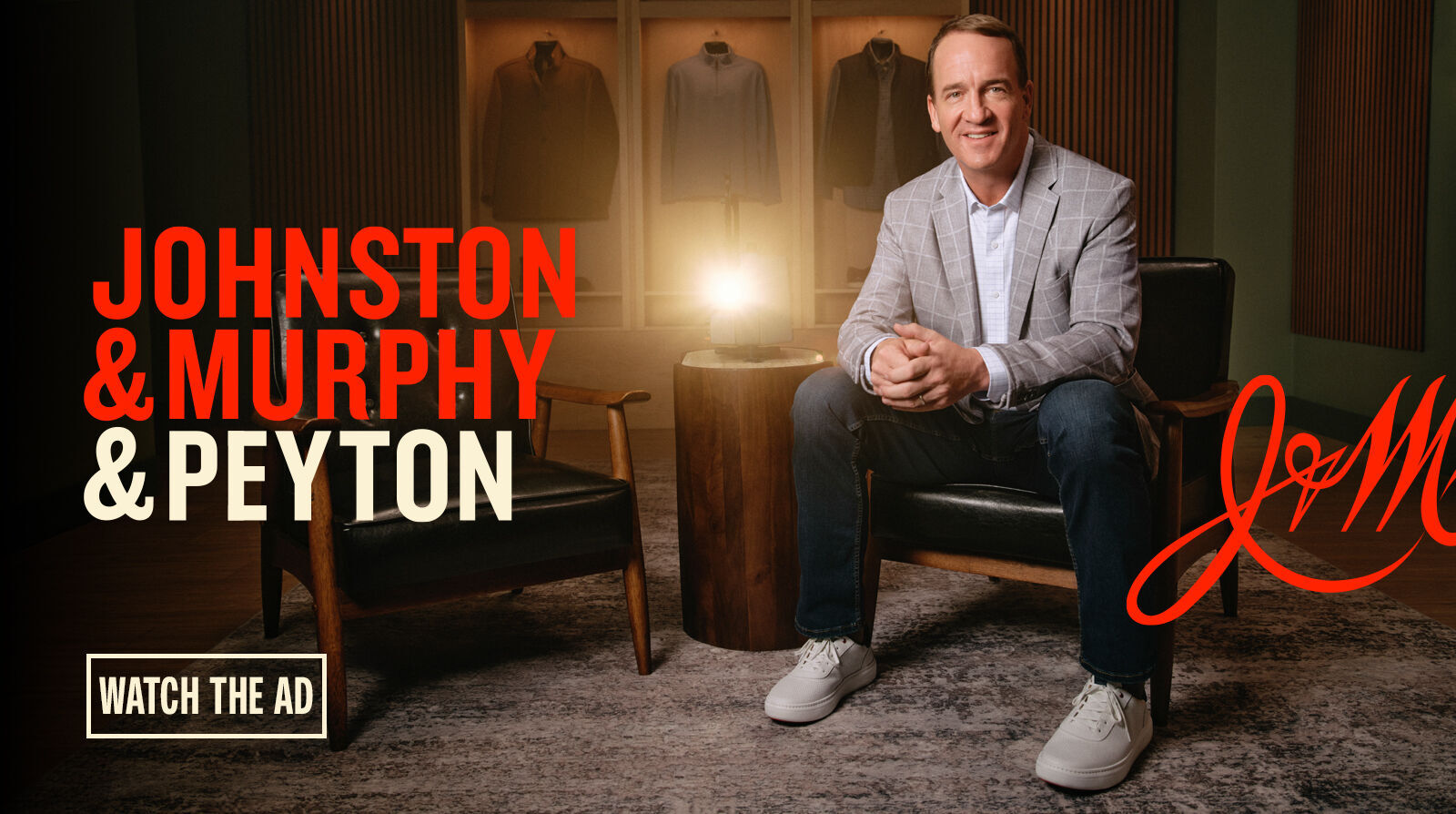 Peyton Manning wearing a styled outfit by Johnston & Murphy. Text that reads "Johnston & Murphy & Peyton" are shown on the left side of the image with a "Watch the ad" button below.